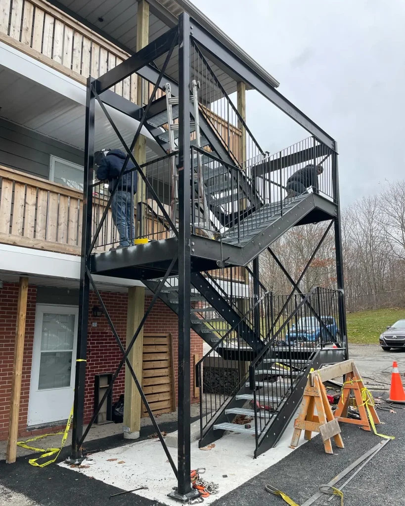 Completed exterior access stair at a residential building by BriteArc Fabricators