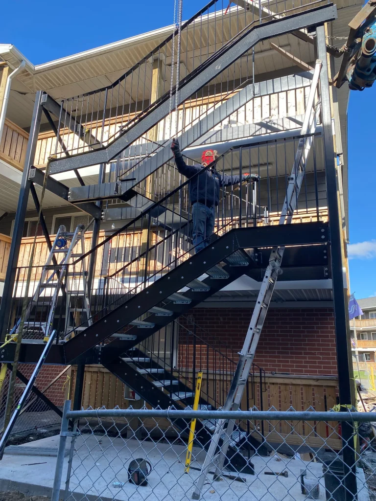 Steel fire escape with guardrails and landings by BriteArc Fabricators