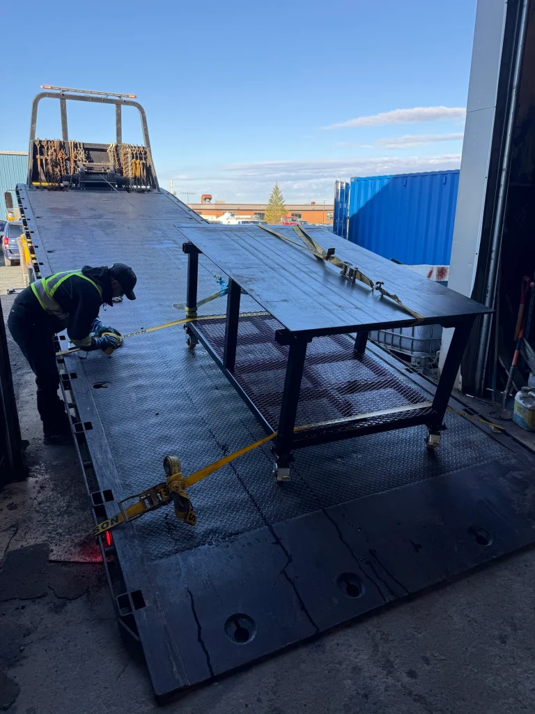 Fabricated steel platform being positioned by crane by BriteArc Fabricators