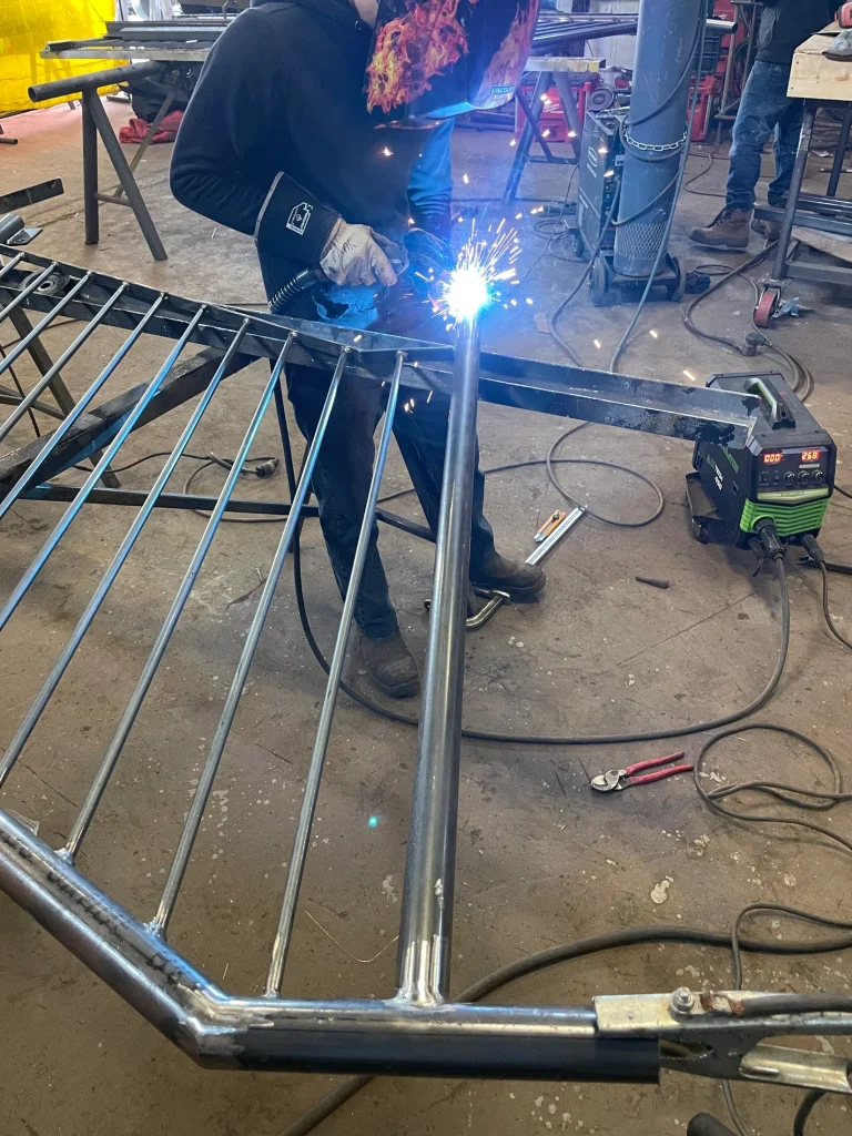 Shop welding on a custom steel railing by BriteArc Fabricators