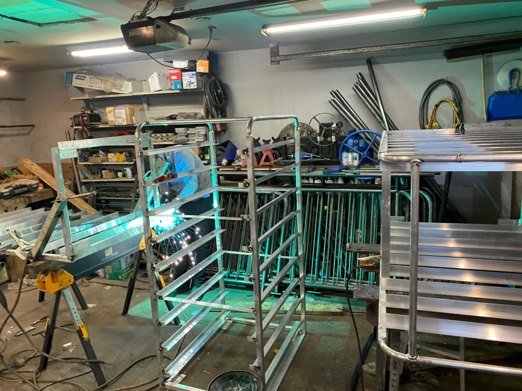 Stainless racks and carts during shop fabrication by BriteArc Fabricators
