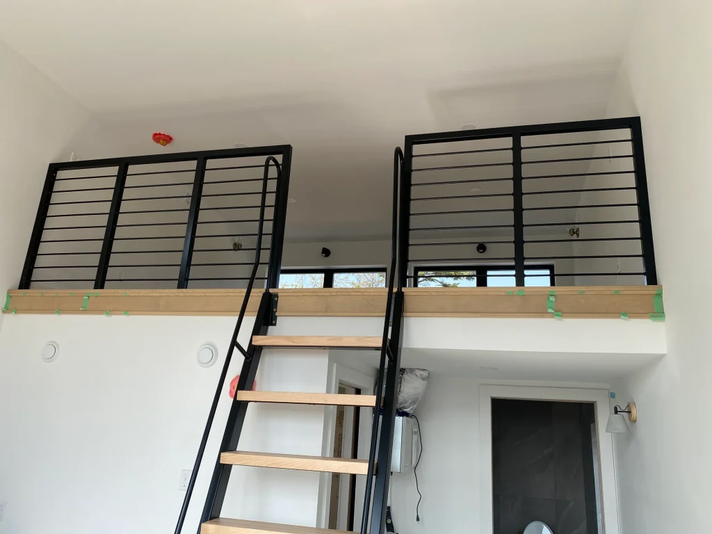 Horizontal-bar guardrails at an interior mezzanine by BriteArc Fabricators
