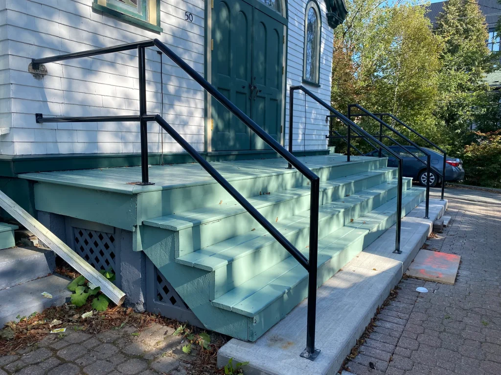 Exterior handrails fitted to architectural concrete stairs by BriteArc Fabricators