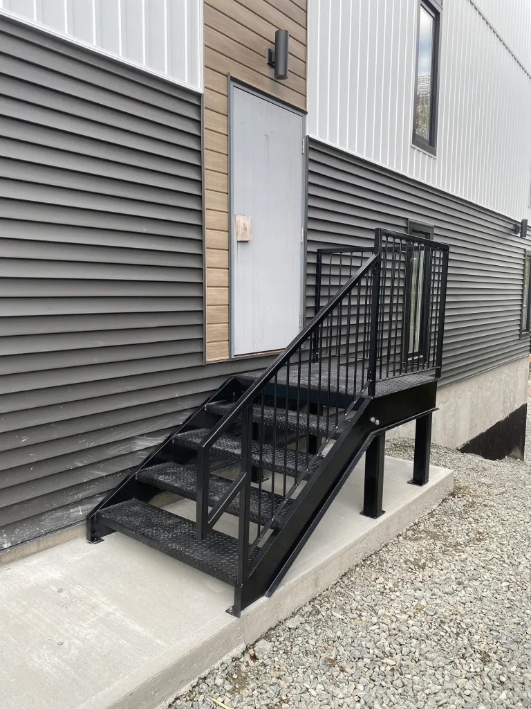 Compact fabricated steel stair and landing by BriteArc Fabricators