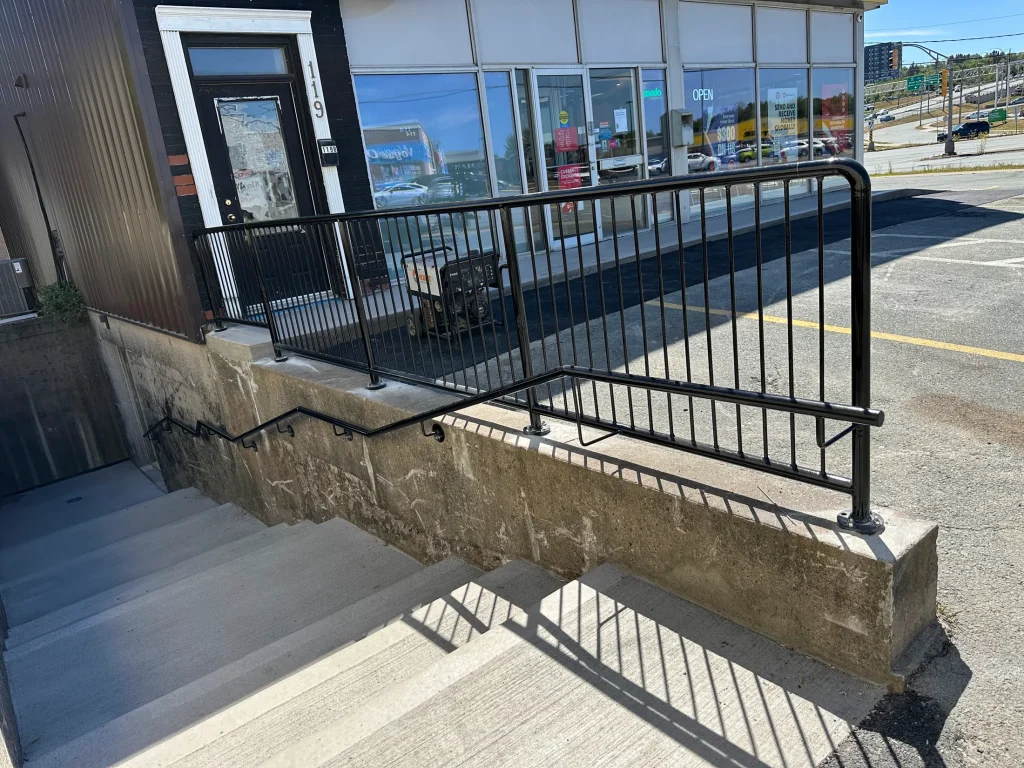 Steel guardrail fitted to a concrete access stair by BriteArc Fabricators