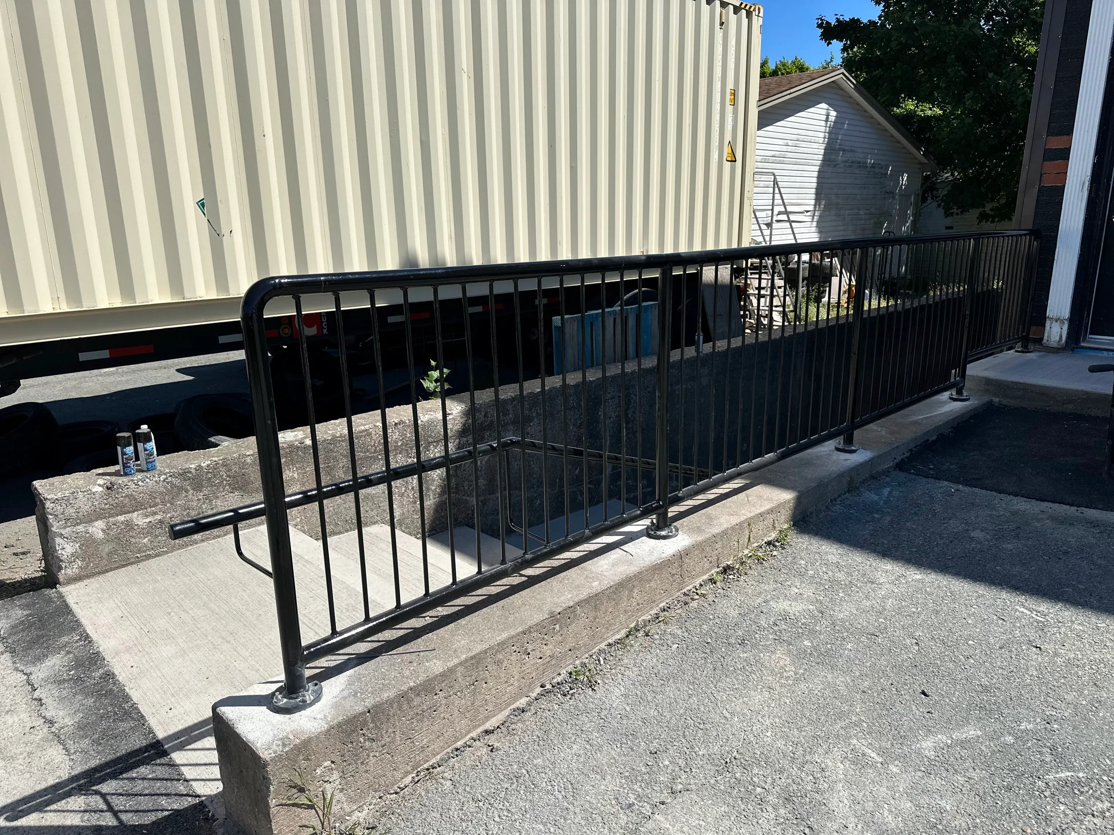 Finished guardrail along an exterior landing by BriteArc Fabricators
