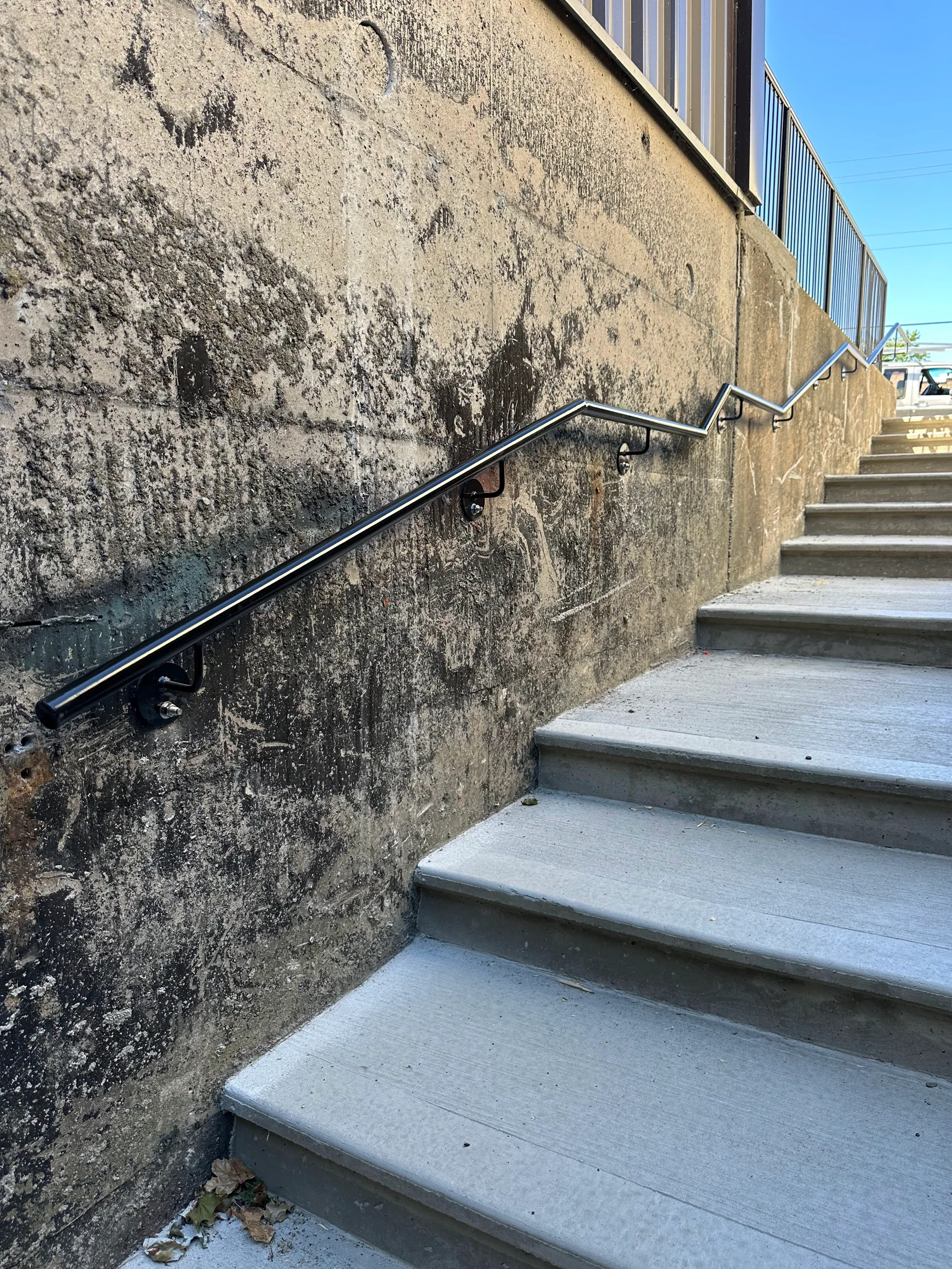 Handrail return and mounting detail by BriteArc Fabricators