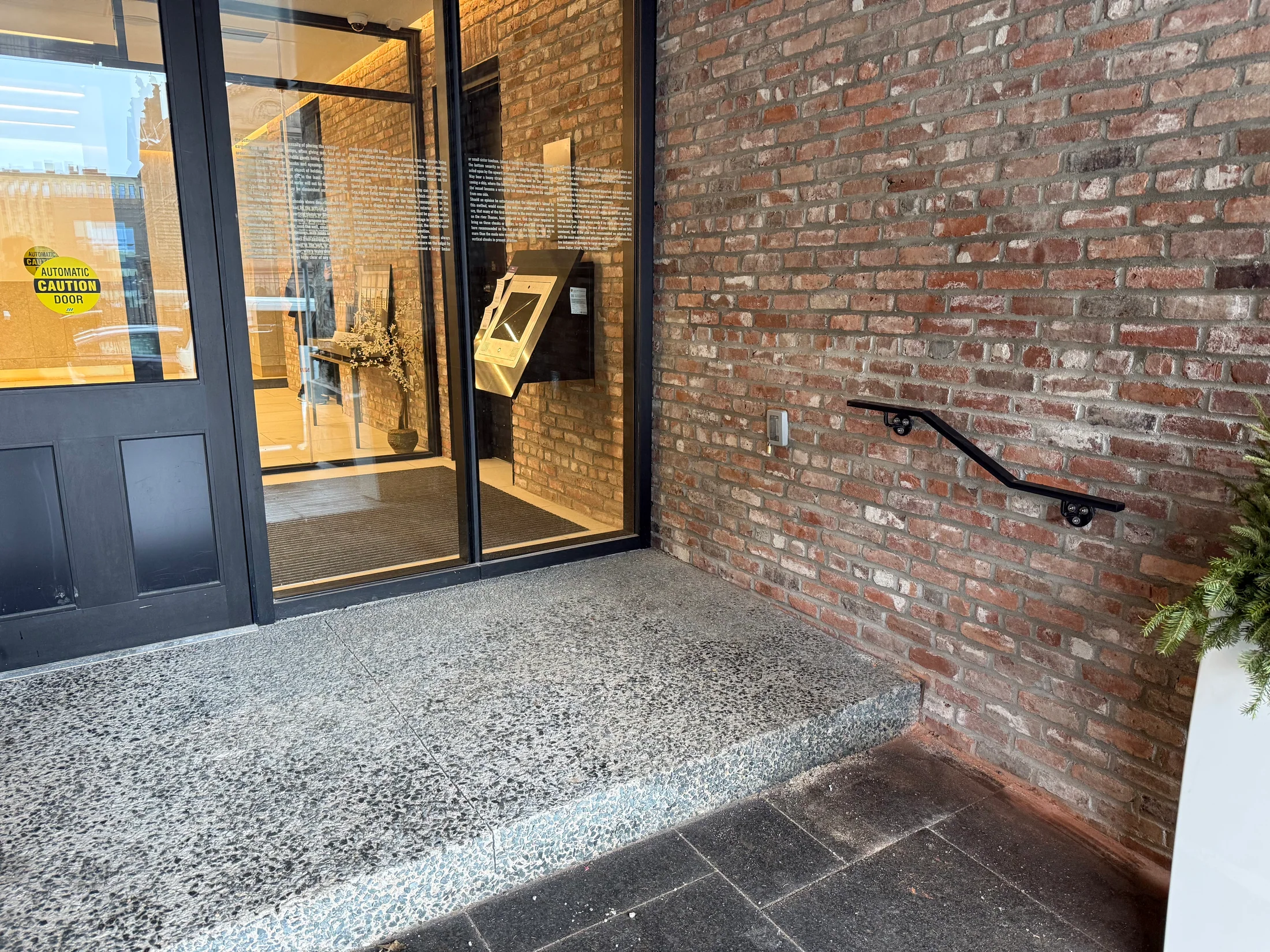Completed handrails at a commercial entrance by BriteArc Fabricators