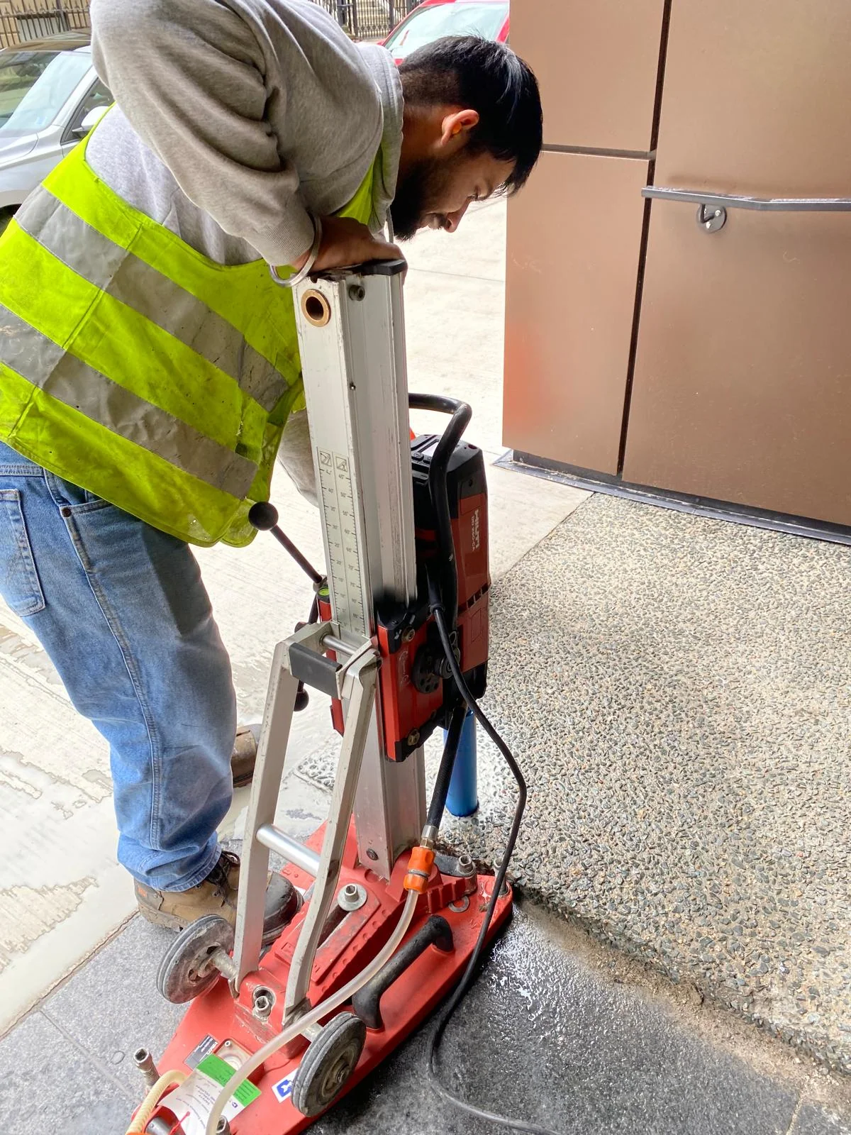 Installer preparing a handrail mounting point by BriteArc Fabricators