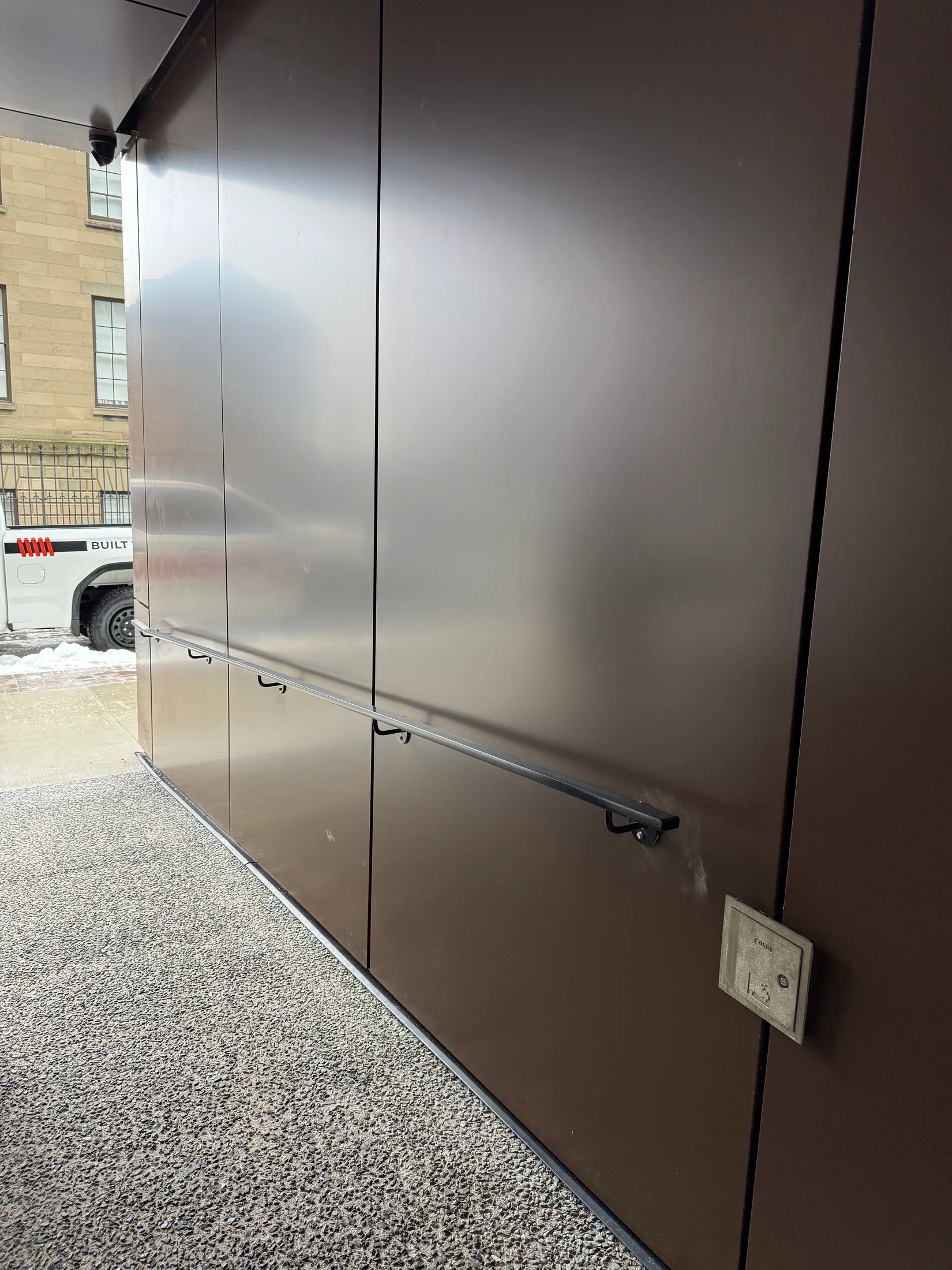 Long handrail run along an exterior wall by BriteArc Fabricators