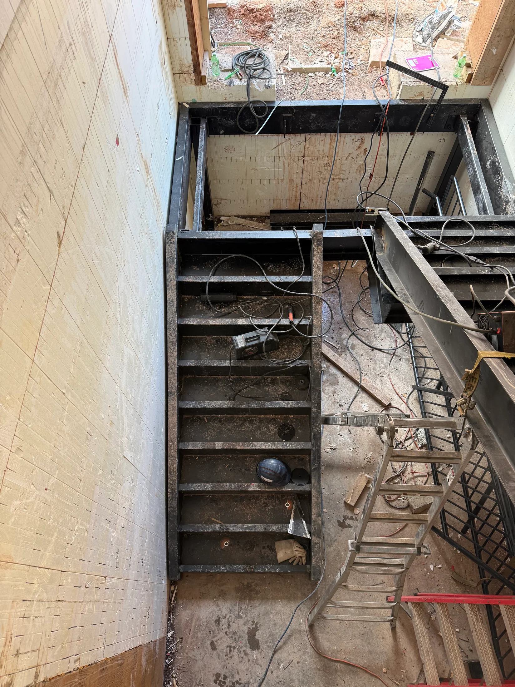 Steel stair package positioned for site installation by BriteArc Fabricators
