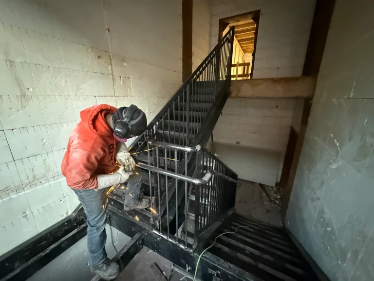 BriteArc fabricator completing field work on a commercial stair guardrail.