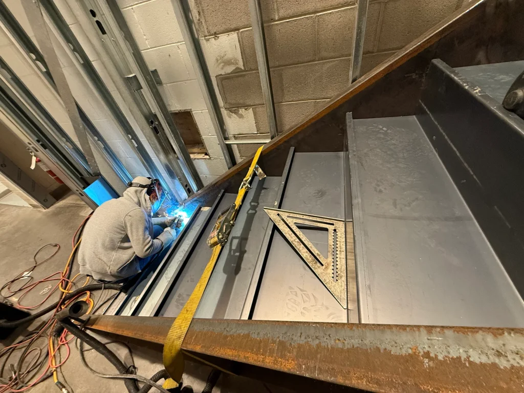 Steel component fitting above an active work area by BriteArc Fabricators