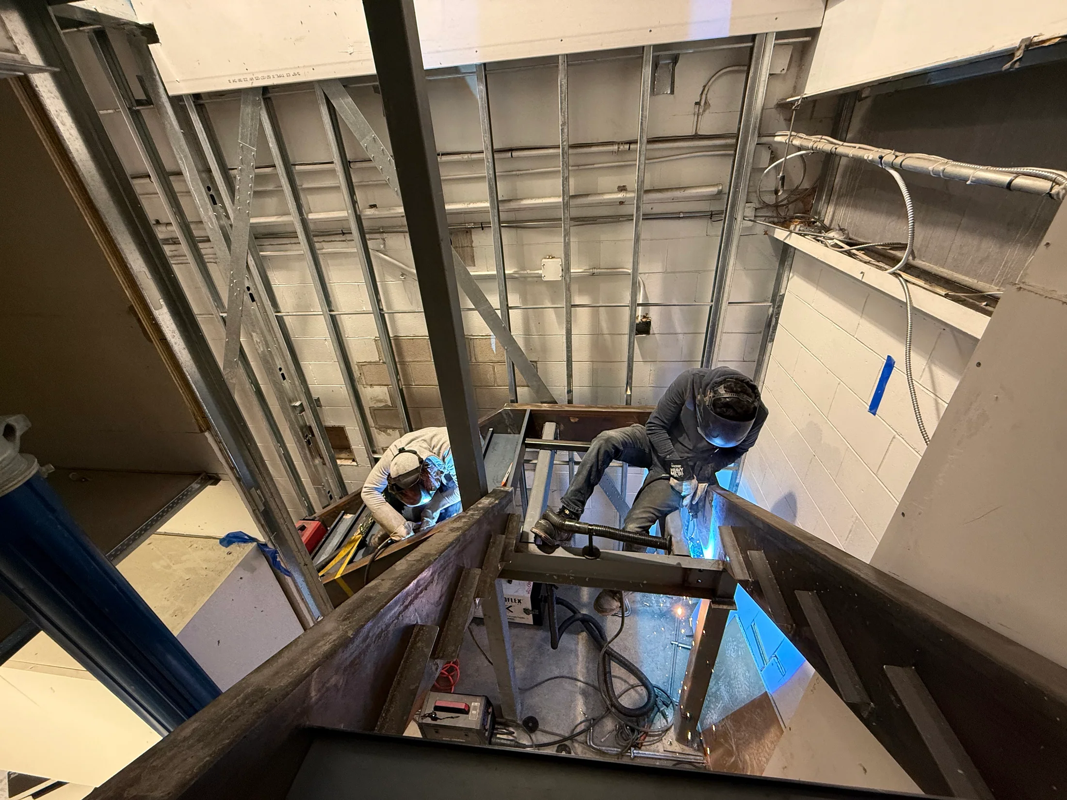 Welder completing an in-place steel connection by BriteArc Fabricators