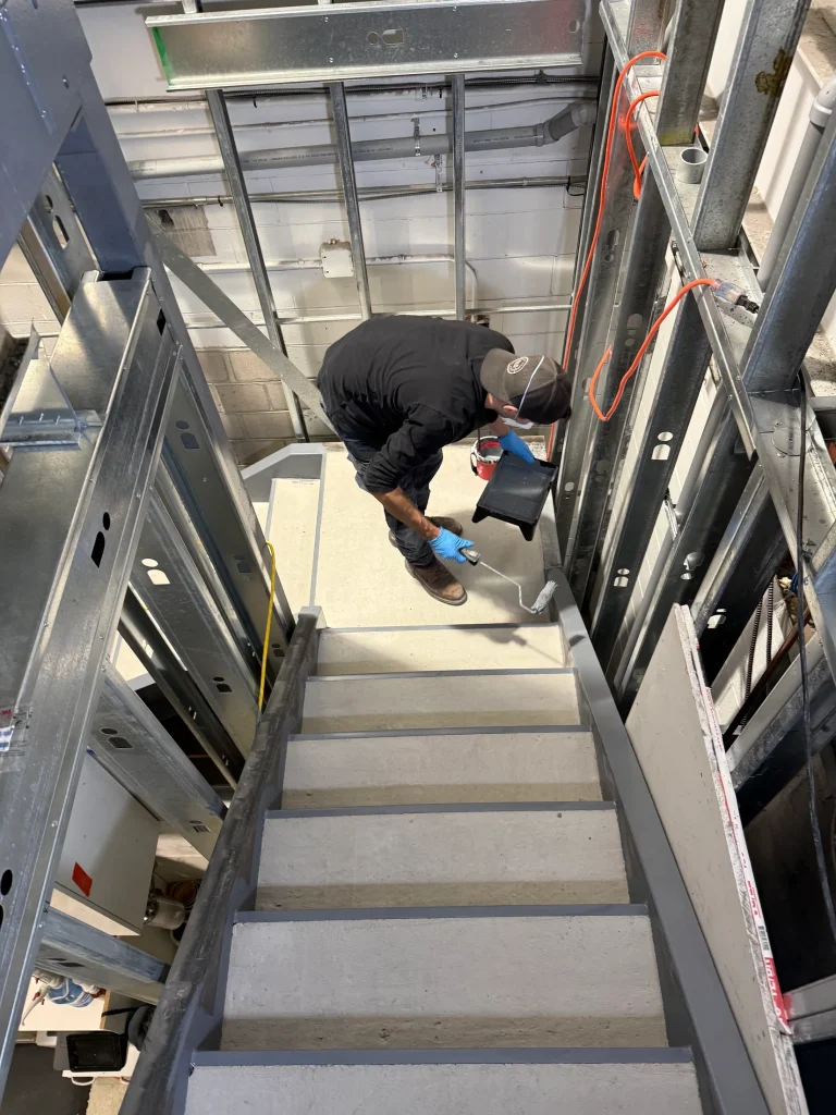 Steel stair assembly during installation by BriteArc Fabricators