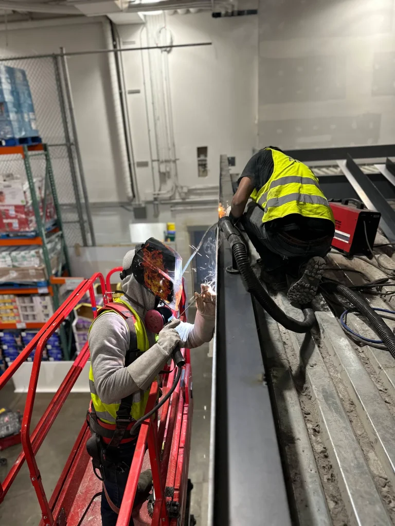Crew completing field connections from a lift by BriteArc Fabricators