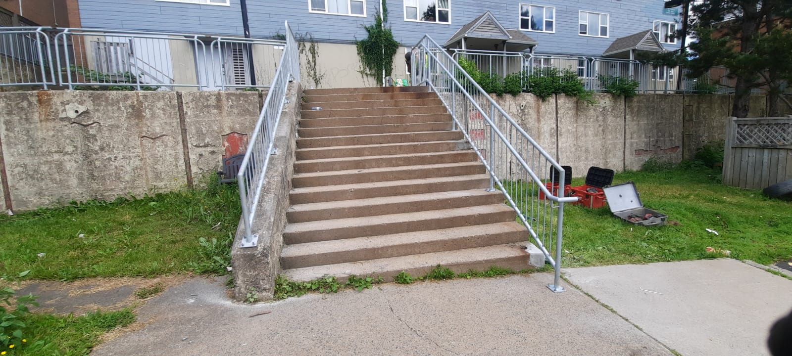 Completed galvanized handrails and guardrails on a wide staircase at Mulgrave Community Park