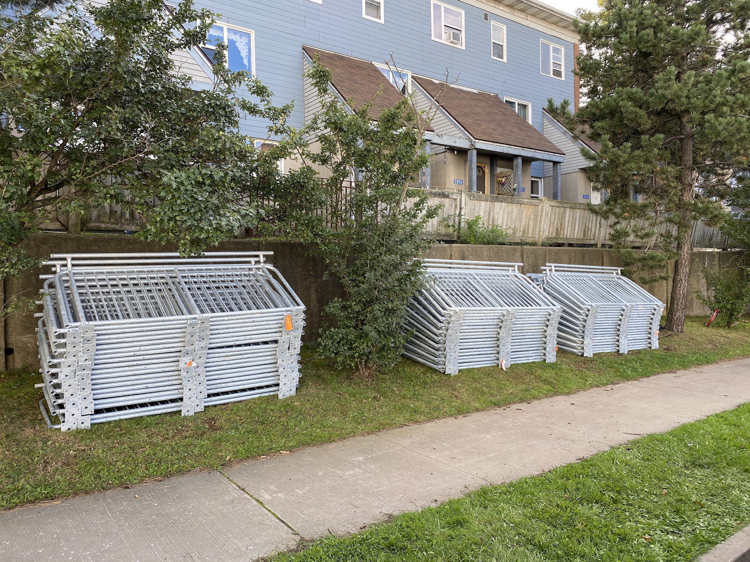 Stacks of galvanized steel railing assemblies ready for installation