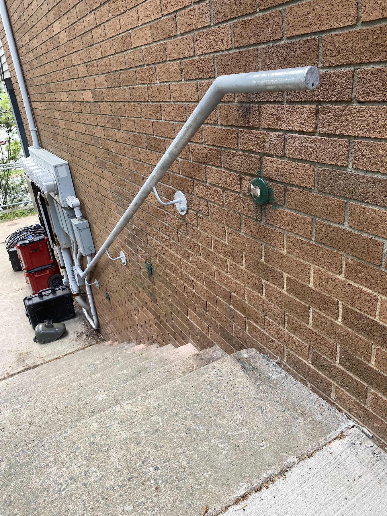 Galvanized guardrail assembly fitted to an existing concrete staircase