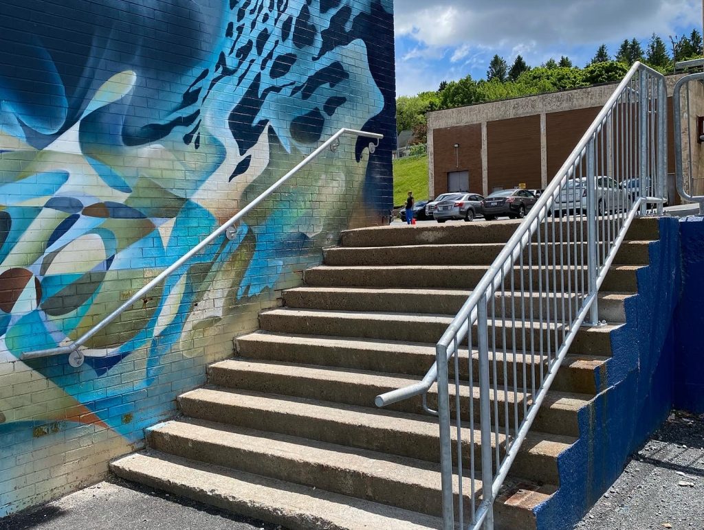 Galvanized stair railings installed beside a mural at Mulgrave Community Park