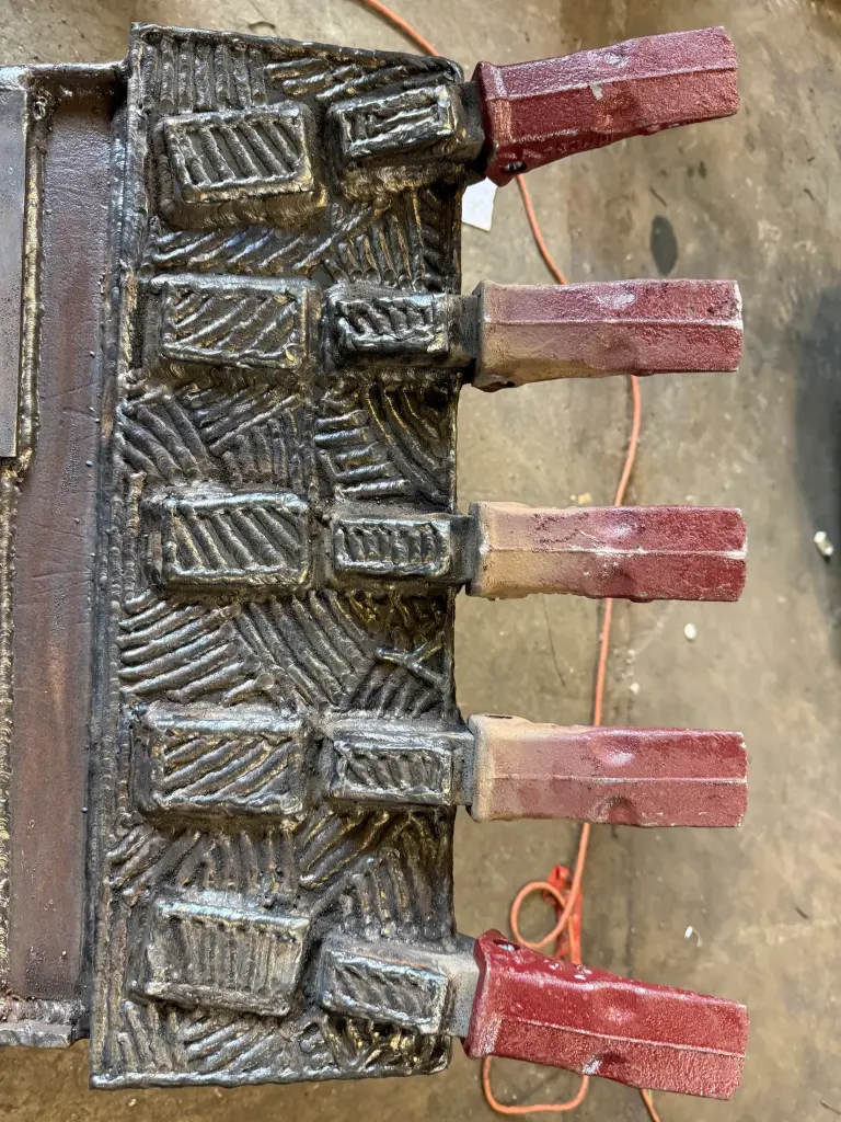 Hardfaced bucket teeth after repair by BriteArc Fabricators