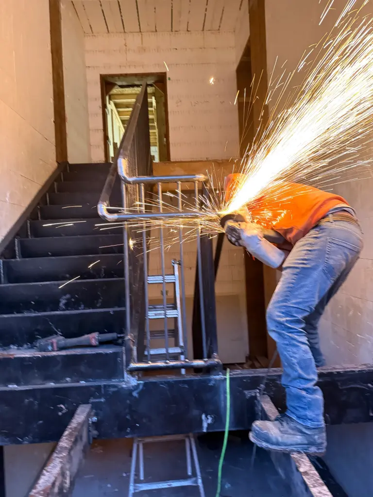 On-site welding at the upper stair landing by BriteArc Fabricators