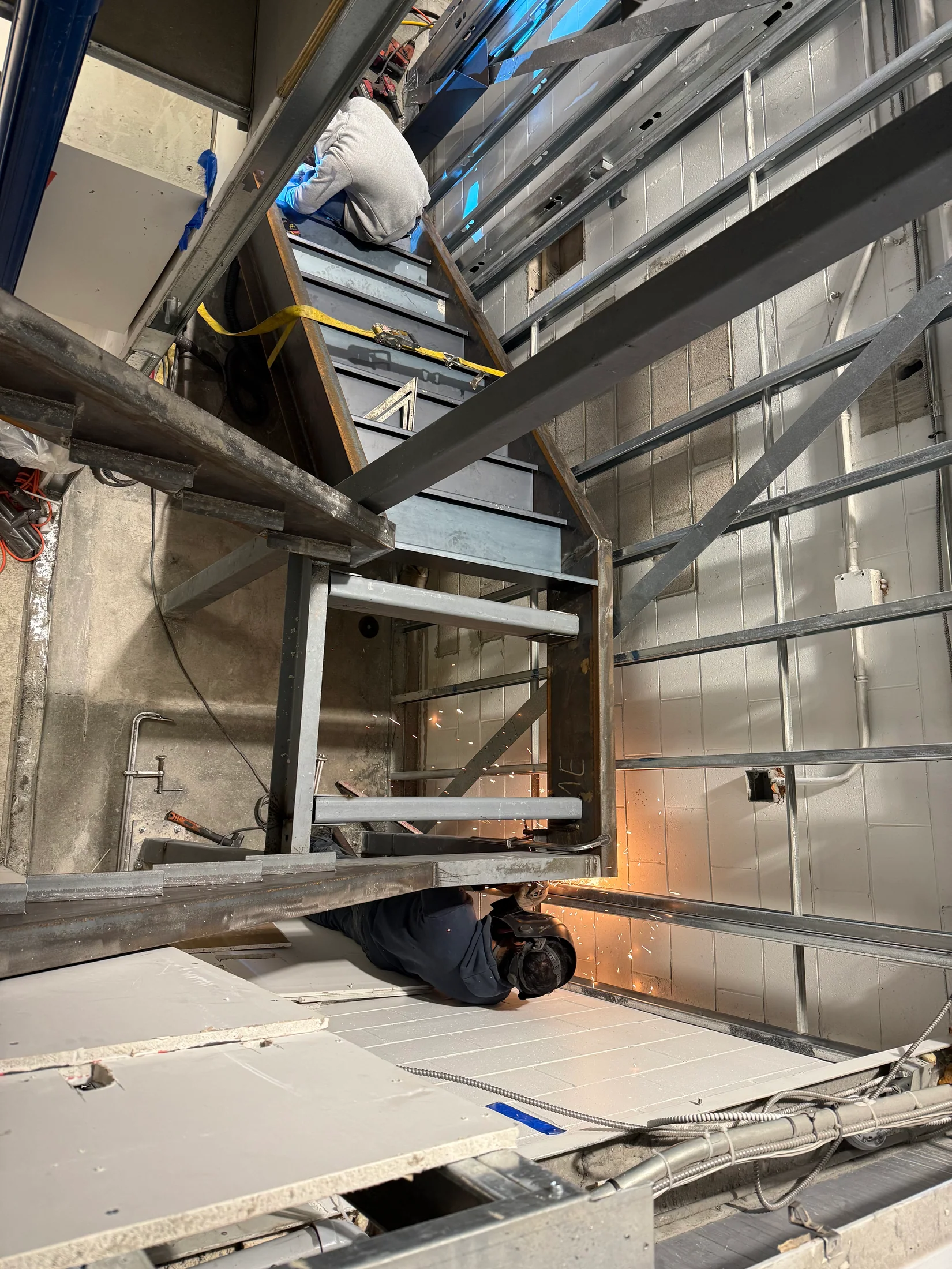 Stair and landing steelwork fitted beside an existing wall by BriteArc Fabricators