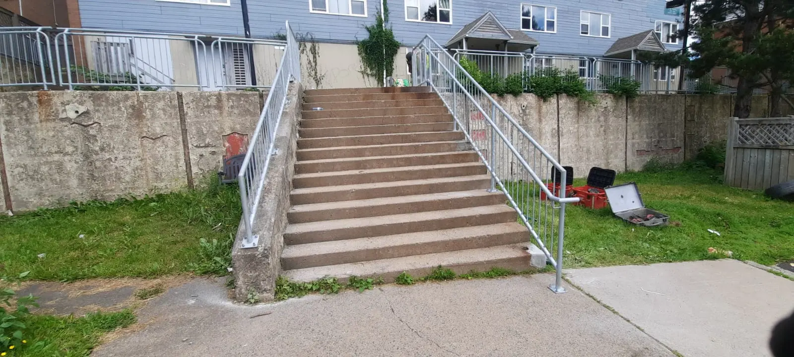 Completed galvanized handrails and guardrails on a wide staircase at Mulgrave Community Park
